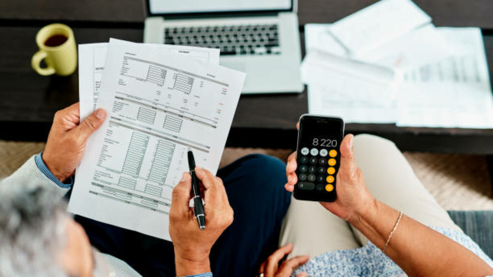 High angle shot of a couple calculating their finances together at home