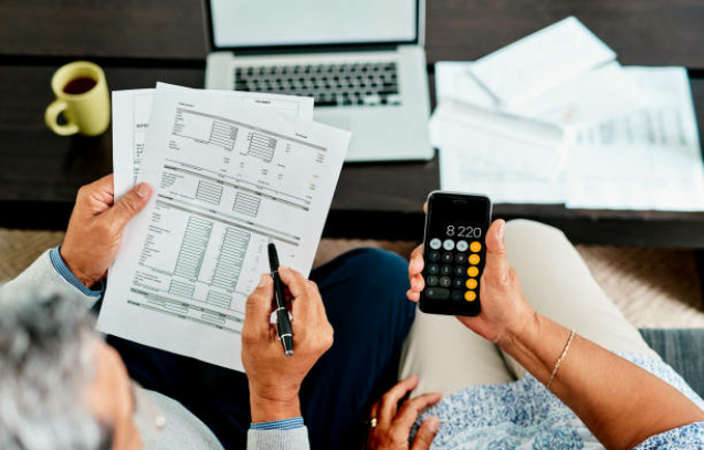 High angle shot of a couple calculating their finances together at home